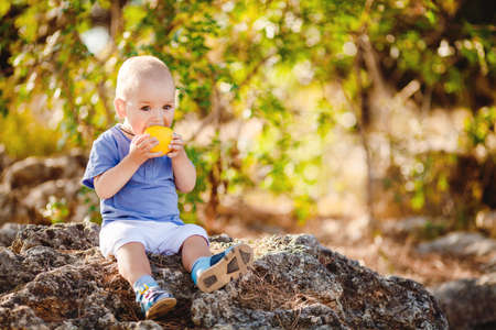 Cute baby boy in summer park outdoors