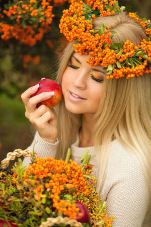 Portrait of smiling beautiful woman wreath of berries in autumn colors