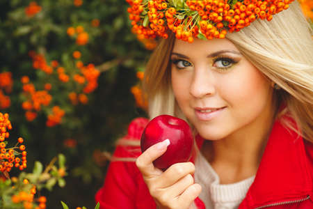 Portrait of smiling beautiful woman wreath of berries in autumn colorsの写真素材