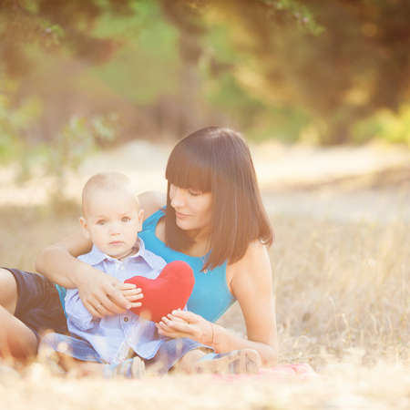Young mother with child outside on a summer day の写真素材