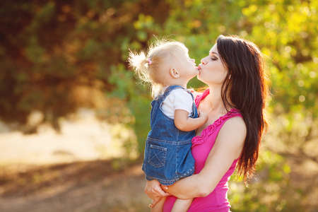 Young mother with child outside on a summer day の写真素材