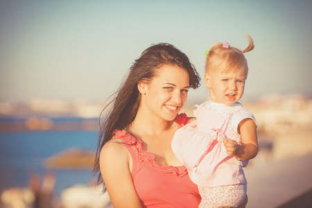 Young mother with child outside on a summer day の写真素材