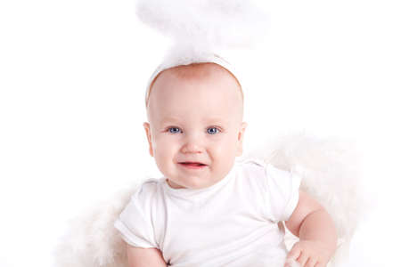 Portrait of Cute baby with angel wings and nimbus sitting on the floor  Studio portrait  Isolated on white backgroundの写真素材