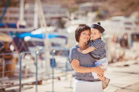 Happy Family having fun by the sea boats and yachtsの写真素材