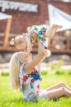 portrait of Smiling mother and little daughter on nature  Happy people outdoorsの写真素材
