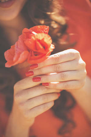beautiful smiling girl against summer blooming bokeh background