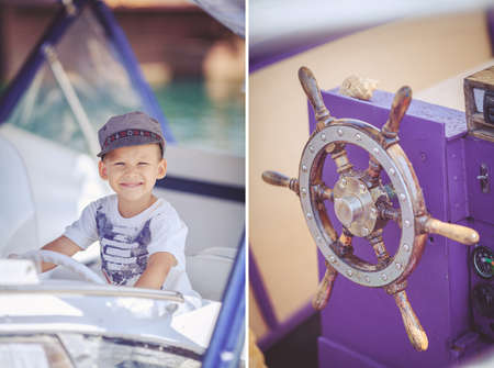 Cute little sailor boy having fan near boats on pier near the sea  Outdoor 