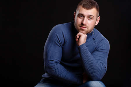 portrait of handsome young muscular man on black backgroundの写真素材