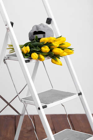 Spring bouquet of yellow tulips isolated on wooden background 