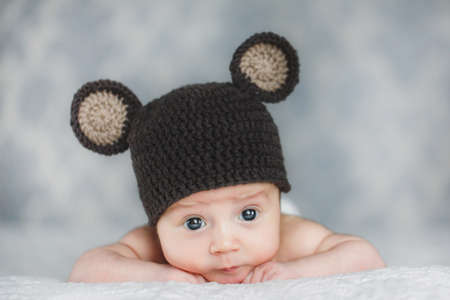 portrait of adorable Cute newborn baby boy in knitted hatの写真素材