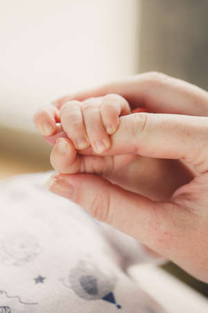 Concept of love and family  hands of mother and baby closeup