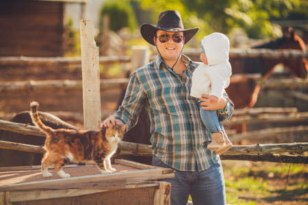 portrait of young father playing with his little daughter in summer park, on countrysideの写真素材