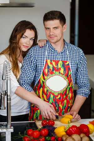 Attractive Couple in Home Kitchen Preparing Vegetable Saladの写真素材