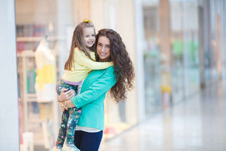 Young mother and her daughter doing shopping togetherの写真素材