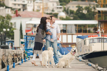 Happy family resting at beach in summer  Happy family with dogs on berth in summerの写真素材