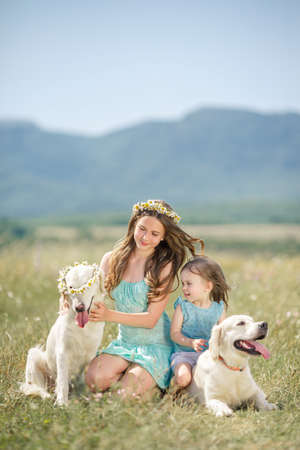 Beautiful girls playing with her dog  Outdoor portrait  series  Woman playing with her dog outdoorsの写真素材