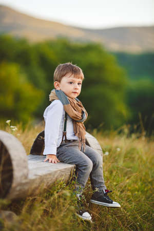 stylish baby boy having fun outside in the park  Cute happy boy child outdoorsの写真素材