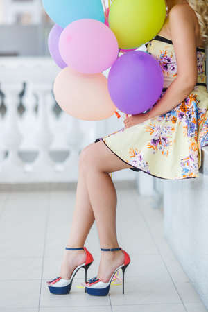 summer holidays, celebration and lifestyle concept - beautiful blonde woman with colorful balloons in the city  Bright summer portraitの写真素材