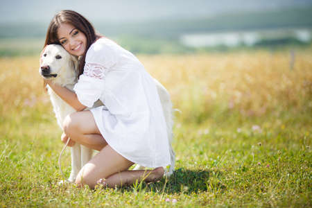 Beautiful woman plays with the dog on the nature  Outdoor portrait  Series  Young woman with dog...