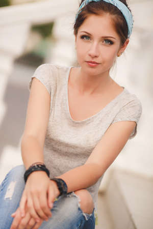 Portrait of a young beautiful smiling brunette outdoorsの写真素材