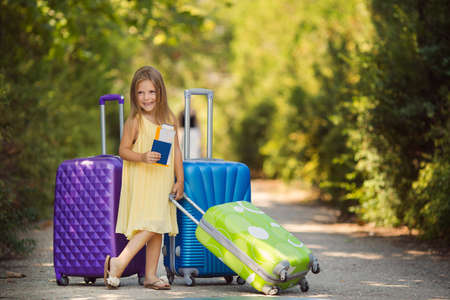 Beautiful young lady travelling with a suitcaseの写真素材