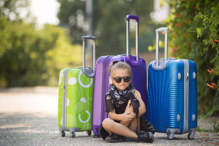 Beautiful young lady travelling with a suitcaseの写真素材