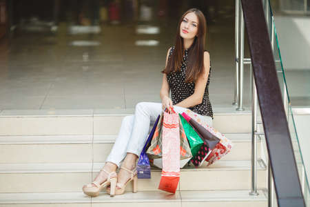 Fashion Shopping Girl Portrait. Beauty Woman with Shopping Bags in Shopping Mall. Shopper. Sales. Shopping Centerの写真素材