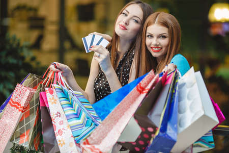 Two women walk fashion stores for shopping.の写真素材