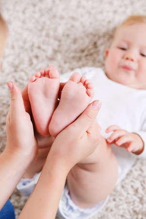 Young mother doing exercises with his young son