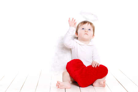 Little angel girl with red big heartの写真素材