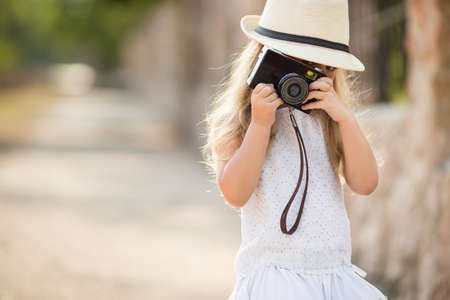 Very small photographer, brunette girl with long beautiful hair in a white dress in light beige hat with black rim, old Dad\\\\\\\\\\\\\\\\の写真素材