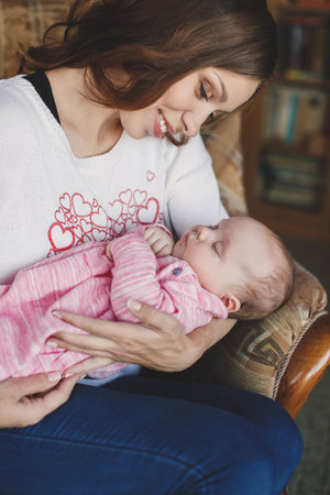 happy mother holding her baby girl. Happy family. A young mother and baby.