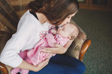 happy mother holding her baby girl. Happy family. A young mother and baby.