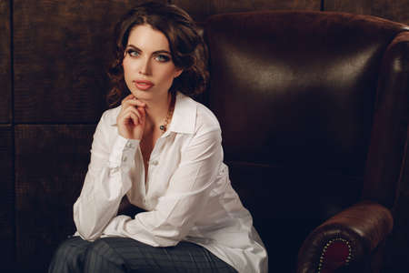 Fashionable woman in luxury dark interior. Business woman. beautiful fashionable woman in interior. Stylish womanの写真素材