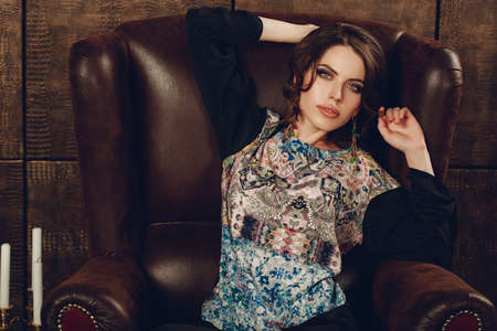 Fashionable woman in luxury dark interior. Business woman. beautiful fashionable woman in interior. Stylish womanの写真素材