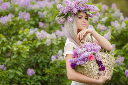 Beautiful smiling girl with long blonde straight hair resting the spring at a Park near the Bush...