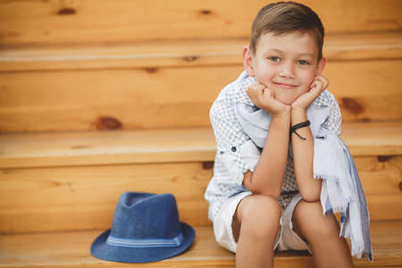 Summer portrait of a little boy near his homeの写真素材