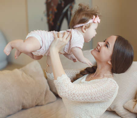 Happy mother holding her baby.Happy, beautiful young mother, an attractive woman, brunette with long...