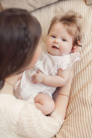 Happy mother holding her baby.Happy, beautiful young mother, an attractive woman, brunette with long...