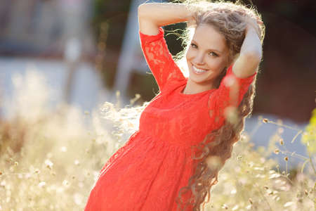 young happy family. man and a pregnant woman happy nature. Happy beautiful pregnant woman with his husband sitting on the lawn outside. Family together in the summer park. Woman is pregnantの写真素材
