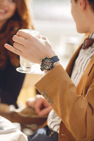 couple in cafe drinking coffee and laughing. Couple drinking coffee at cafe restaurant man and woman with cup of espresso hot cappuccino on dating. Concept of male and female hands love and coffee.の写真素材