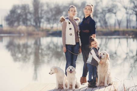 Three sisters, beautiful girls, brunettes, hair pulled back, spend time together with their beloved...