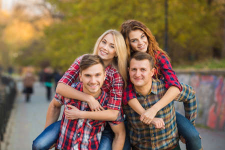 Group Of Friends Having Fun Together Outdoors. Happy group of friends talking and having fun outdoors. friends outdoor. women and men together having fun in city park.の写真素材