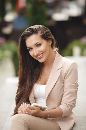 Young beautiful woman brunette with long straight hair, long black eyelashes, and gray eyes, nice...
