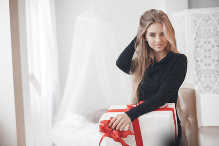 A young beautiful woman with a pleasant smile and big gray eyes, a blonde with long straight hair, isolated on white background for Valentine's Dayの写真素材