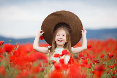 Little girl is wearing a red brim dressingの写真素材