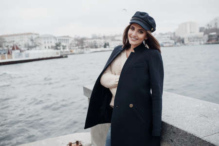 It is a woman who is wearing a pink sweater, a girl who is wearing a white sweater and a hair. woman in a capの写真素材