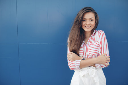 Fashion portrait of a sensual woman. White skirt and a striped blouse. Gorgeous portrait of a...