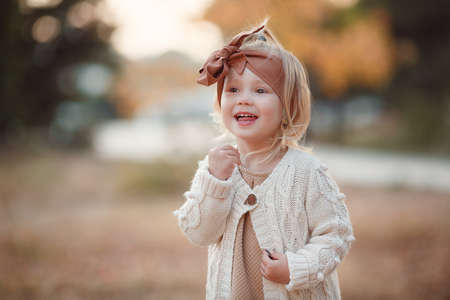 Little fashionista. Happy girl on autumn day. Little girl happy smiling with autumn leaves. Girls autumn style.の写真素材