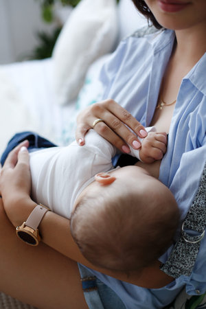 Baby eating mothers milk. Mother breastfeeding baby. Beautiful mom breastfeeding her newborn child.